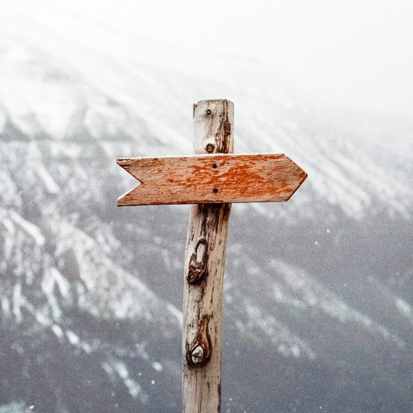 Wegweiser vor einem Berg